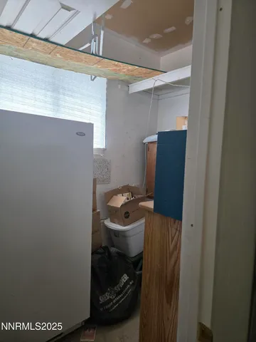 a kitchen with a sink a stove and wooden cabinets