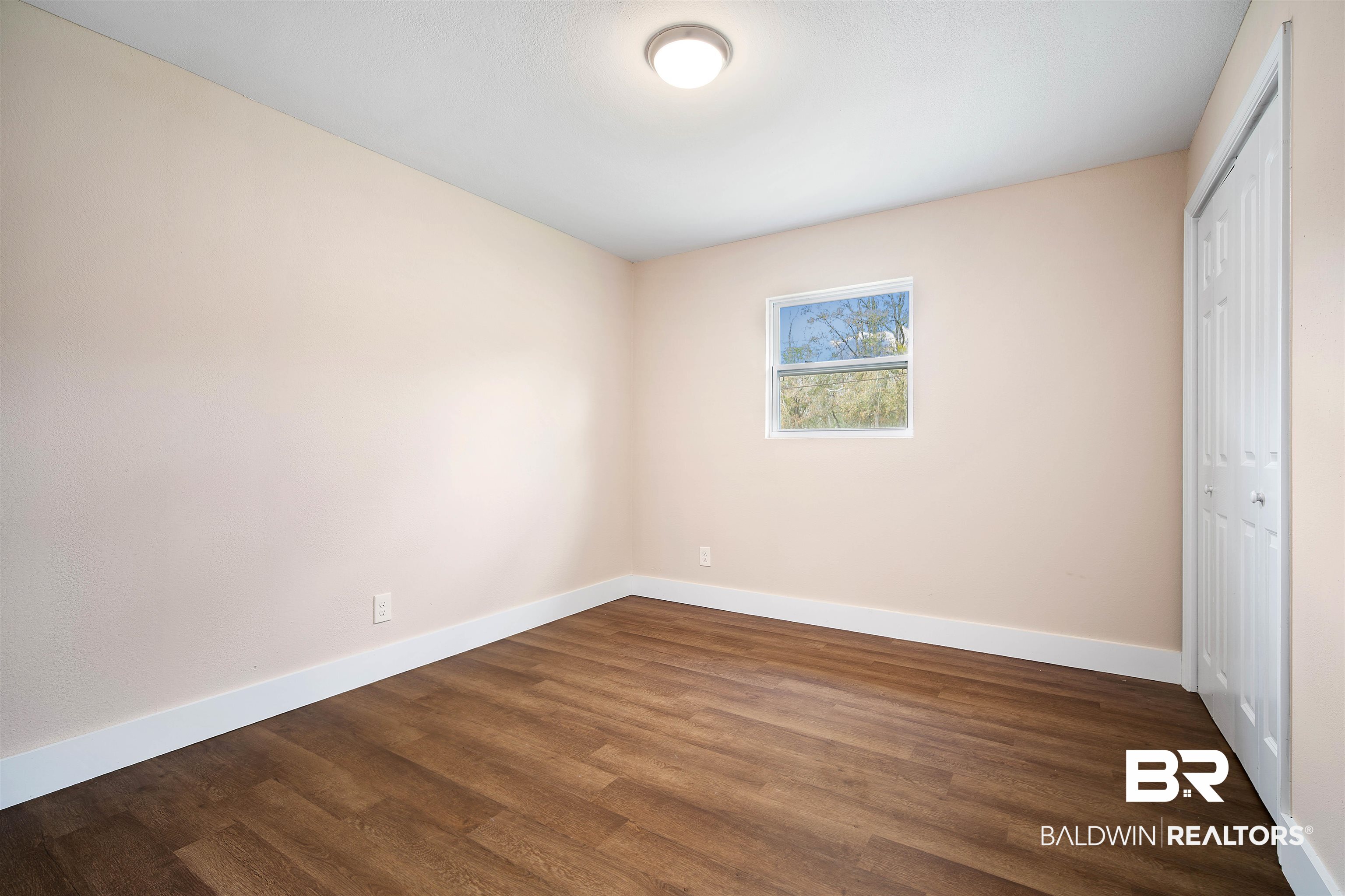 2119 Autrey Avenue Eight Mile, AL 36613 - Photo 17 of 22 Unfurnished bedroom with dark hardwood / wood-style floors and a closet