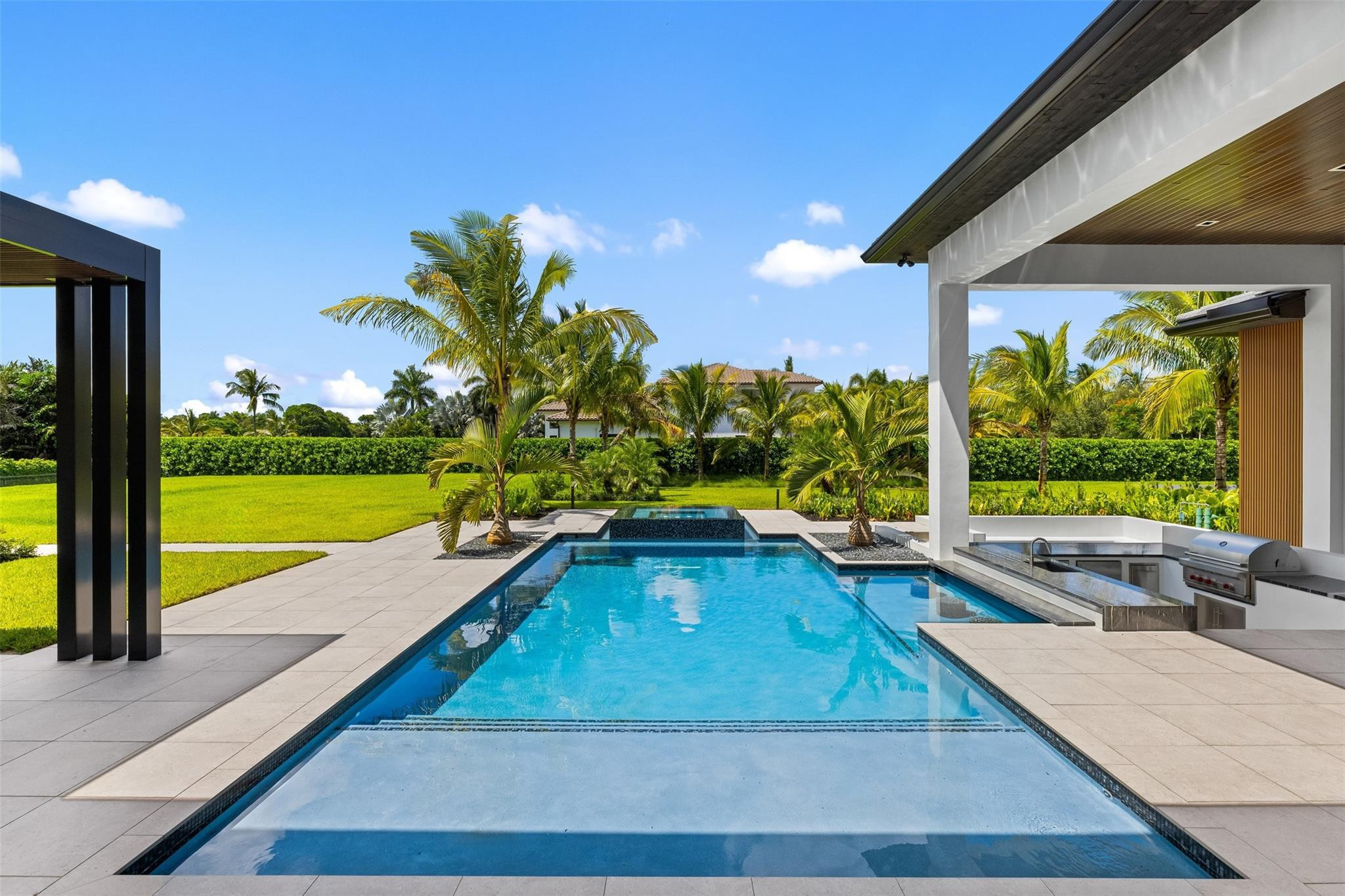 12701 Luray Road Southwest Ranches, FL 33330 - Photo 35 of 44 a view of swimming pool with a patio and a garden