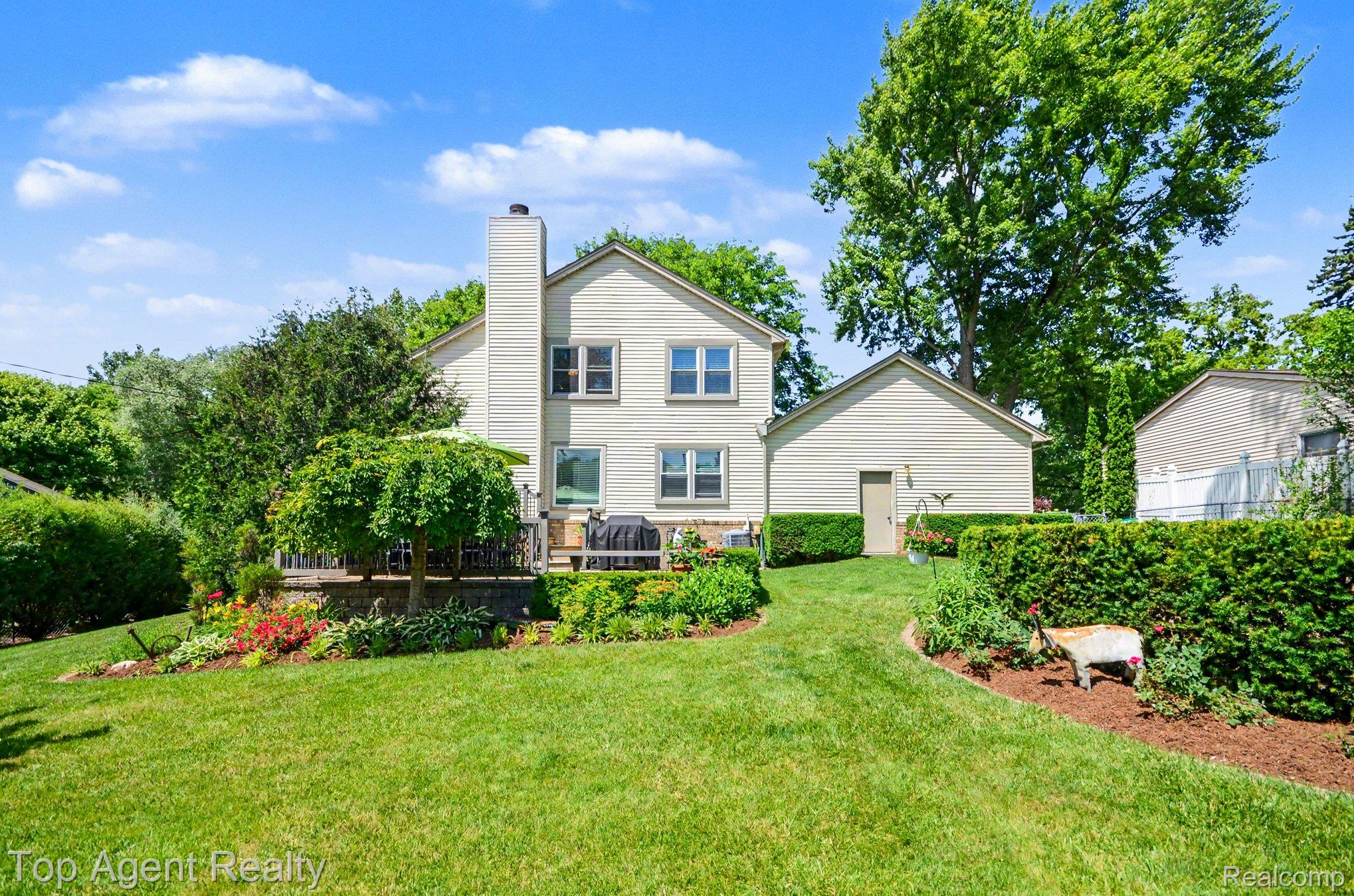 3759 Donley Avenue Rochester, MI 48309 - Photo 22 of 29 Expansive rear yard featuring a manicured lawn, established landscaping beds, and mature trees