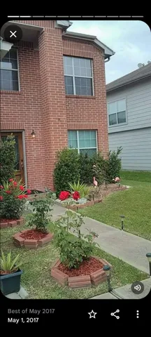 a view of a house with a yard and potted plants