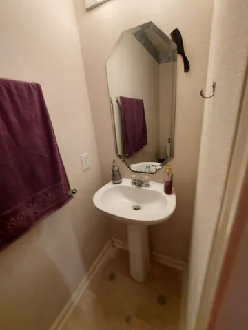 a bathroom with a sink a mirror and vanity