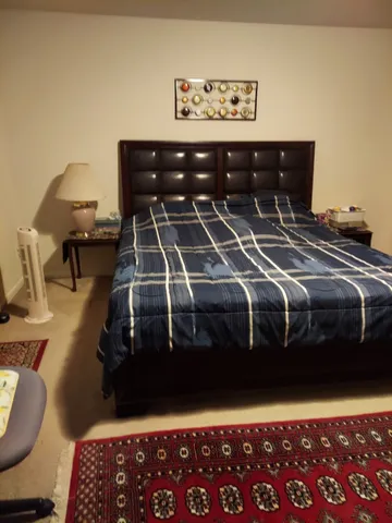 a bedroom with a bed and a chandelier