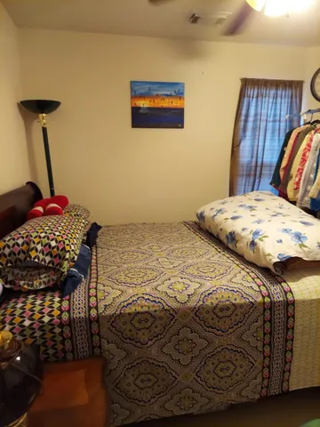 a bedroom with a bed and dresser