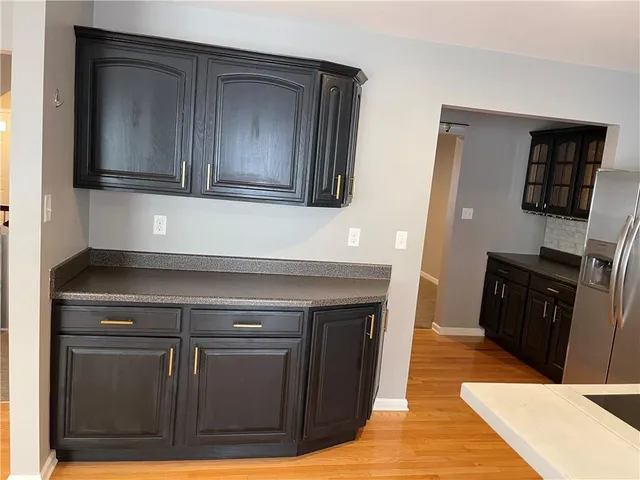 a kitchen with wooden cabinets and a fireplace