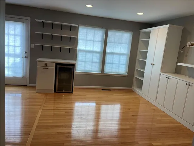 a view of an empty room with a fireplace and a window