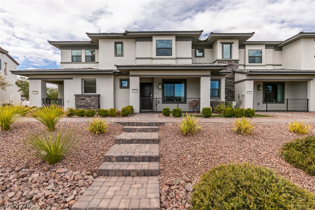 653 Pickled Pepper Place Henderson, NV 89011 - Photo 1 of 35 A contemporary facade greets visitors with a charming covered porch and an inviting paver walkway.
