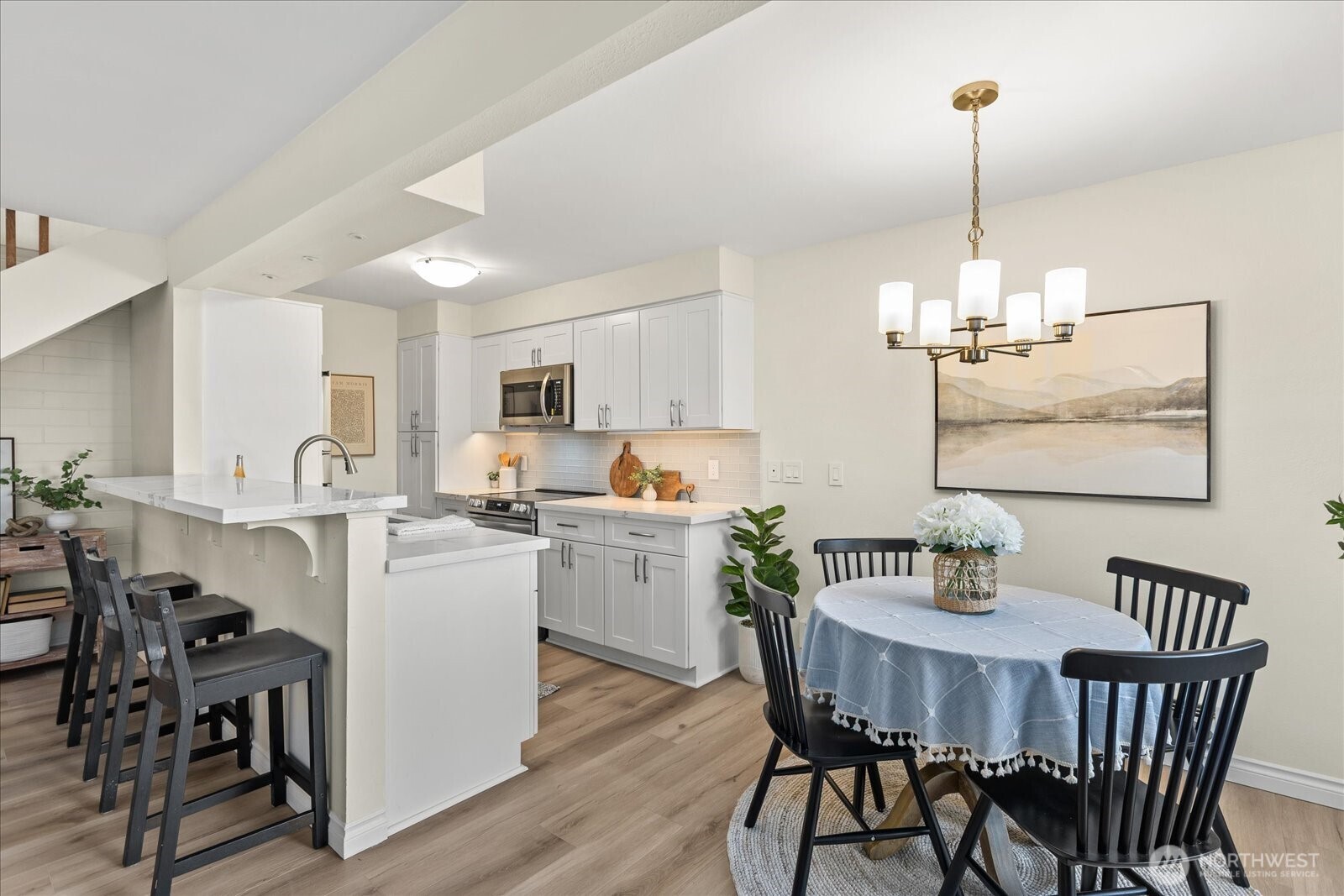410 214th Street Southwest, Unit B Bothell, WA 98021 - Photo 1 of 37 a dining room with furniture a chandelier and wooden floor