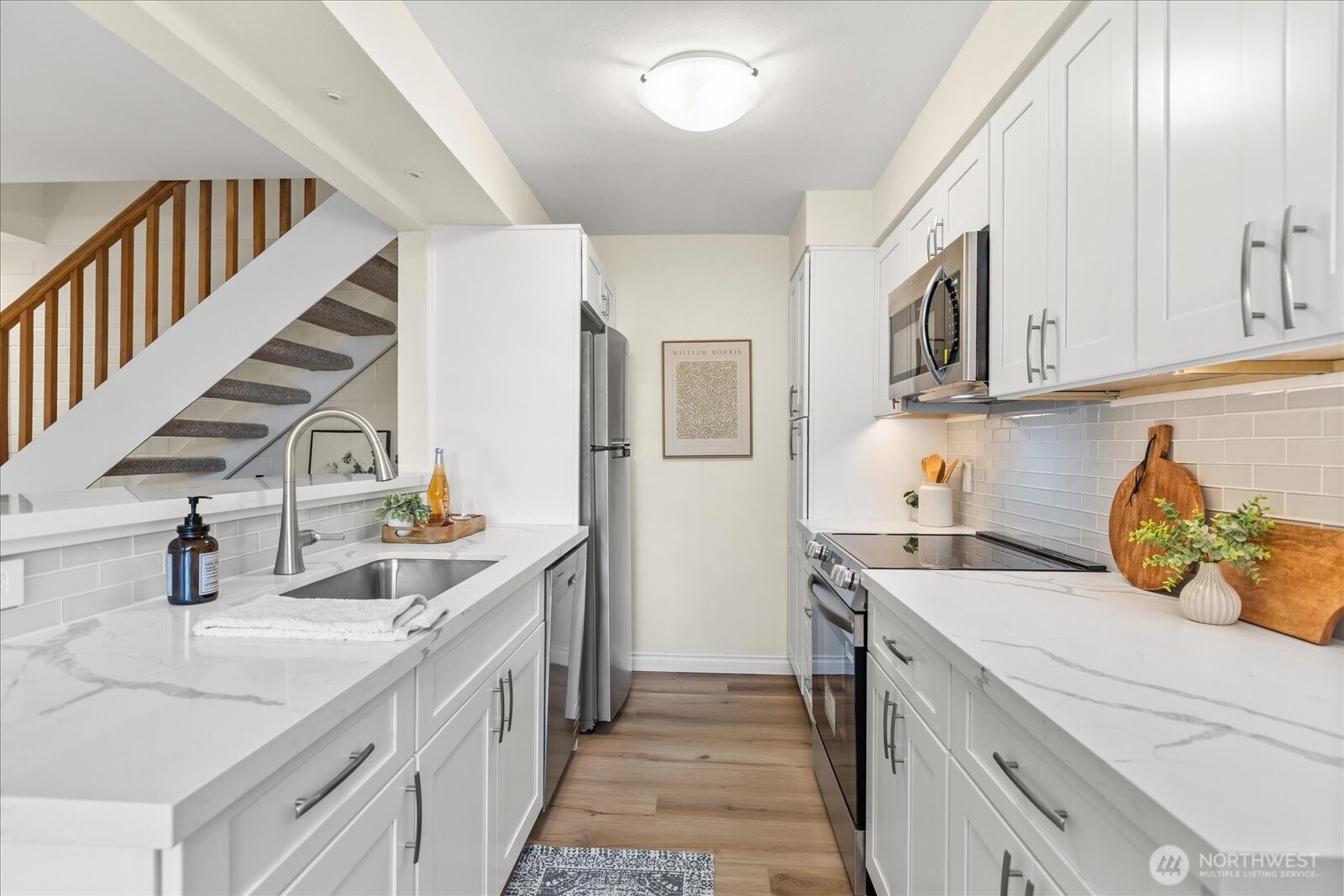 410 214th Street Southwest, Unit B Bothell, WA 98021 - Photo 15 of 37 a kitchen with a sink stove and cabinets
