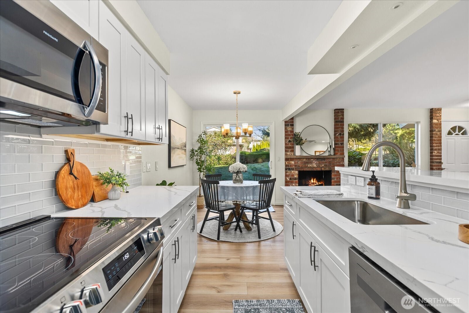 410 214th Street Southwest, Unit B Bothell, WA 98021 - Photo 16 of 37 a kitchen with a table chairs stove and microwave
