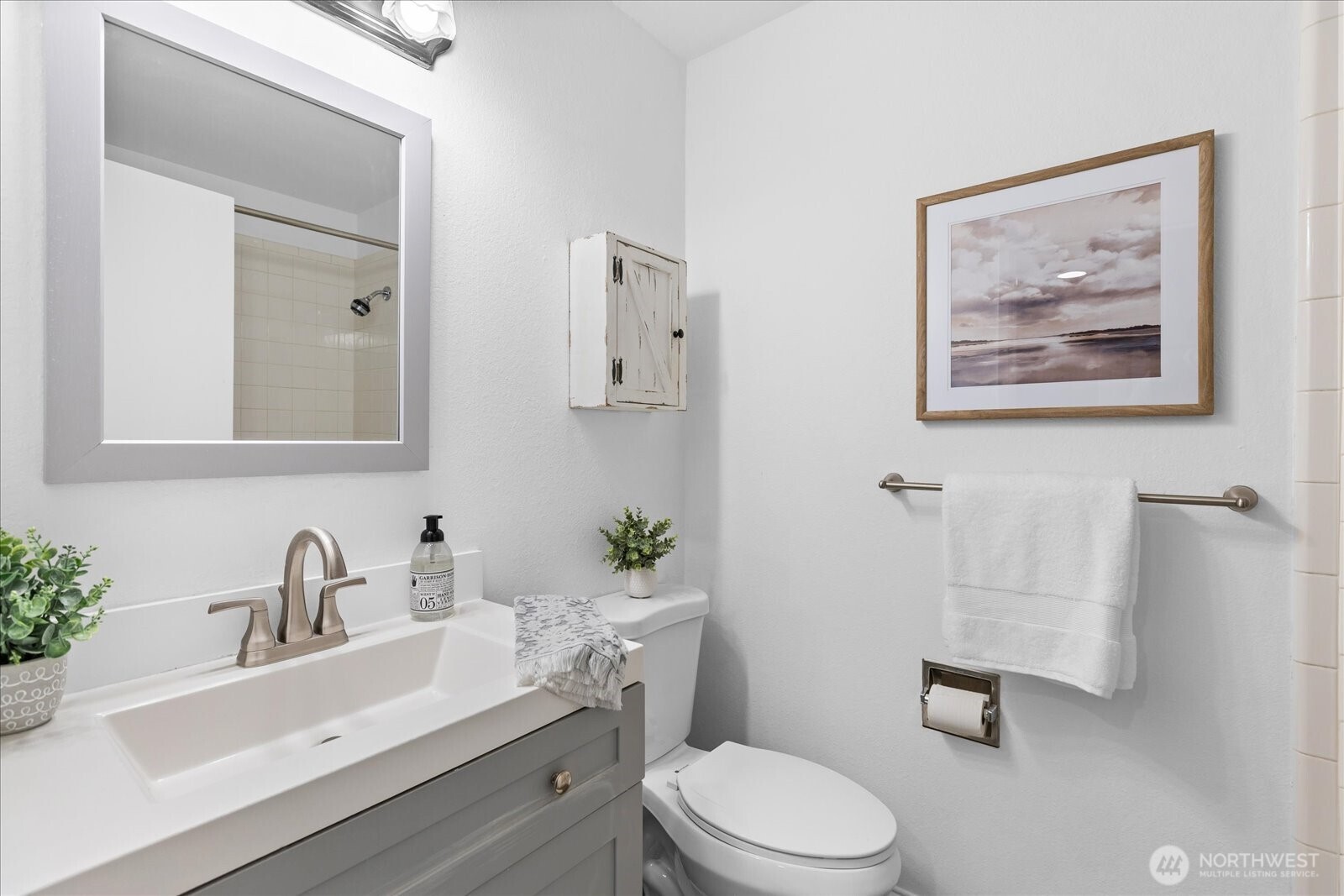 410 214th Street Southwest, Unit B Bothell, WA 98021 - Photo 21 of 37 a bathroom with a toilet a sink and mirror