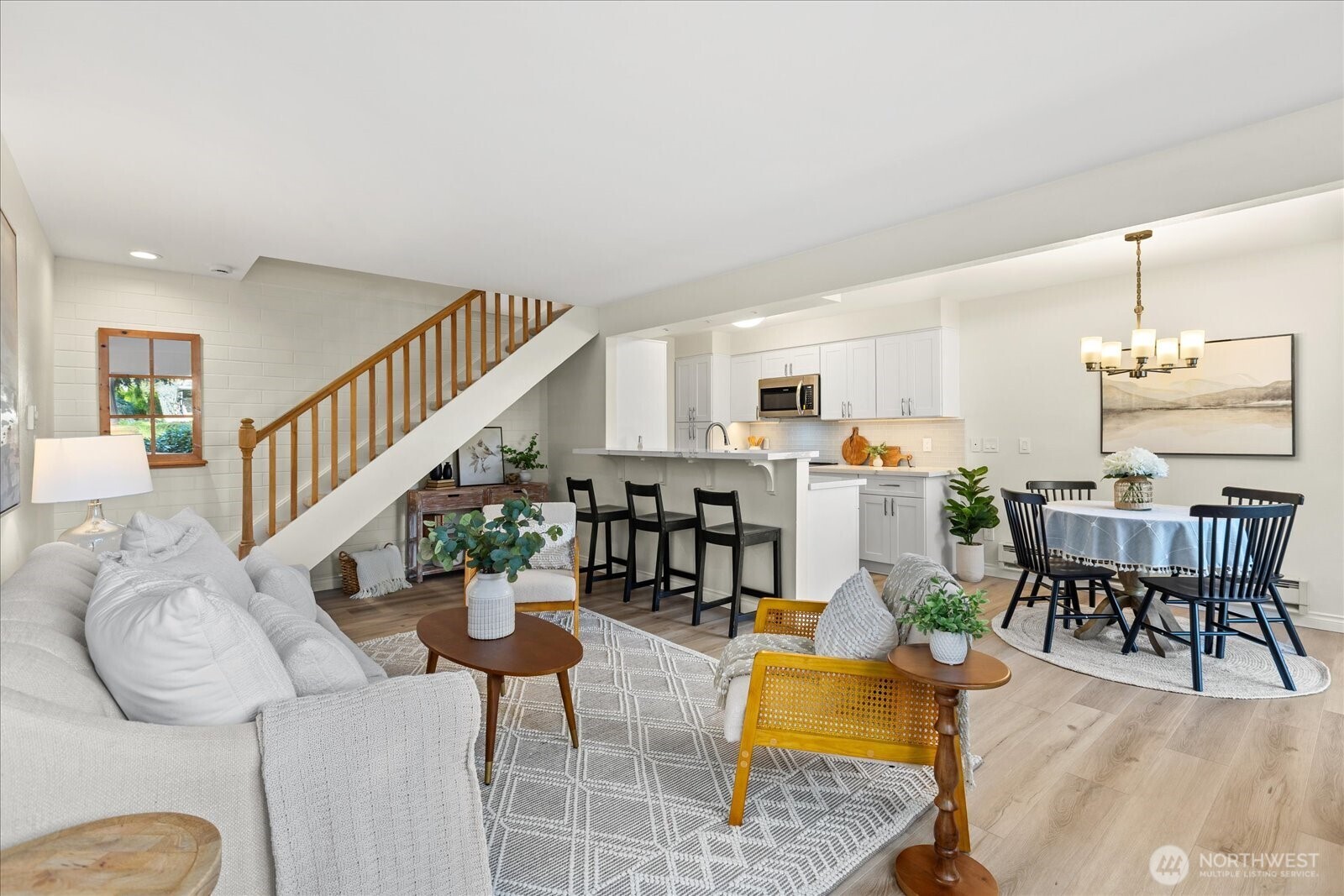 410 214th Street Southwest, Unit B Bothell, WA 98021 - Photo 3 of 37 a living room with furniture kitchen view and a wooden floor