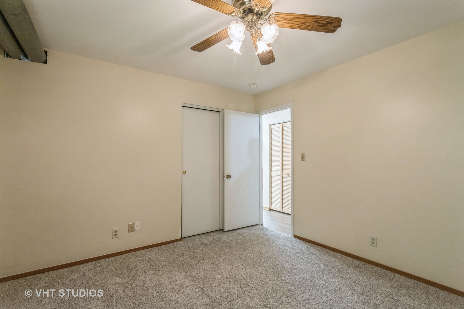 148 Springleaf Drive Bolingbrook, IL 60440 - Photo 12 of 24 an empty room with a chandelier fan and a chandelier fan