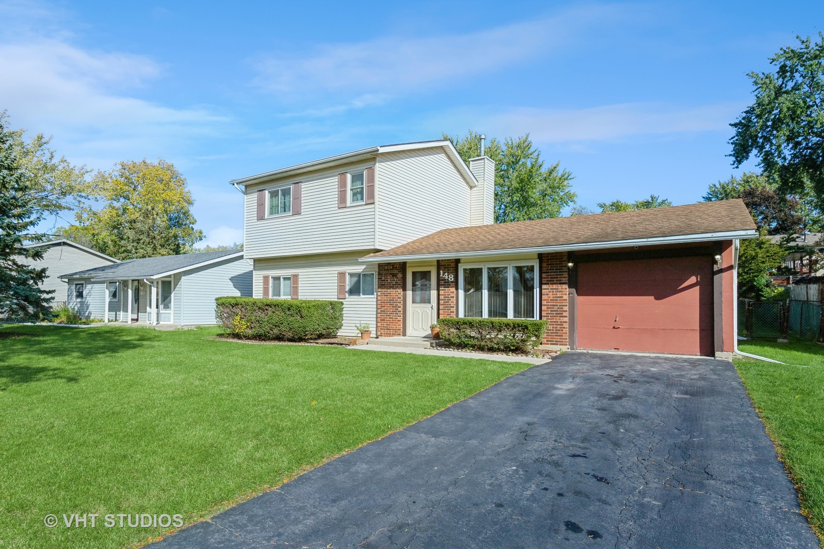 148 Springleaf Drive Bolingbrook, IL 60440 - Photo 2 of 24 a front view of a house with a yard and garage