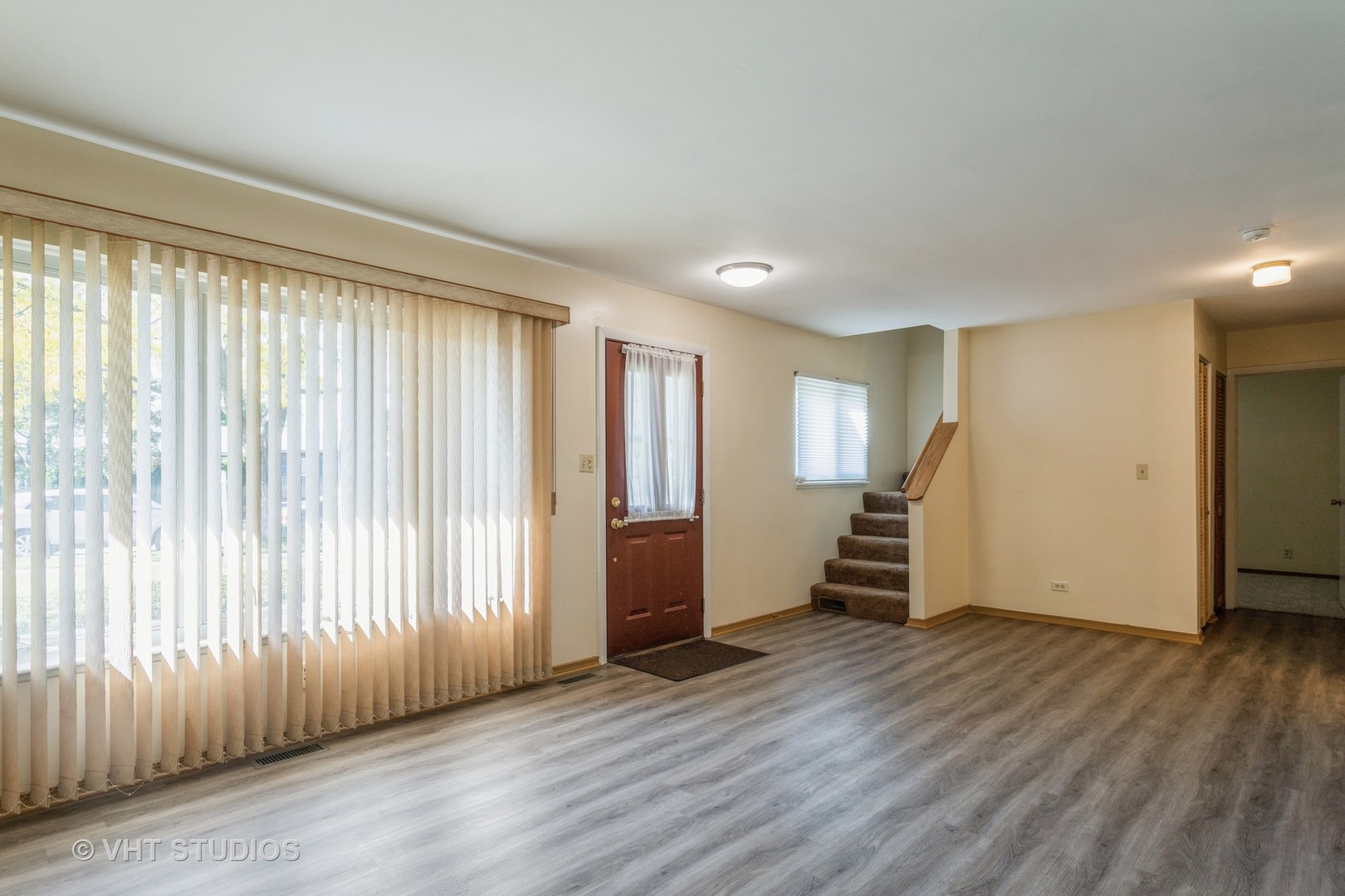 148 Springleaf Drive Bolingbrook, IL 60440 - Photo 3 of 24 an empty room with wooden floor and stairs