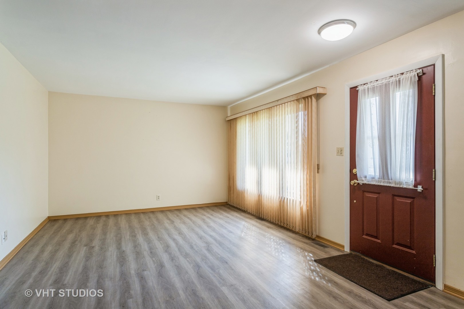 148 Springleaf Drive Bolingbrook, IL 60440 - Photo 4 of 24 an empty room with wooden floor and windows