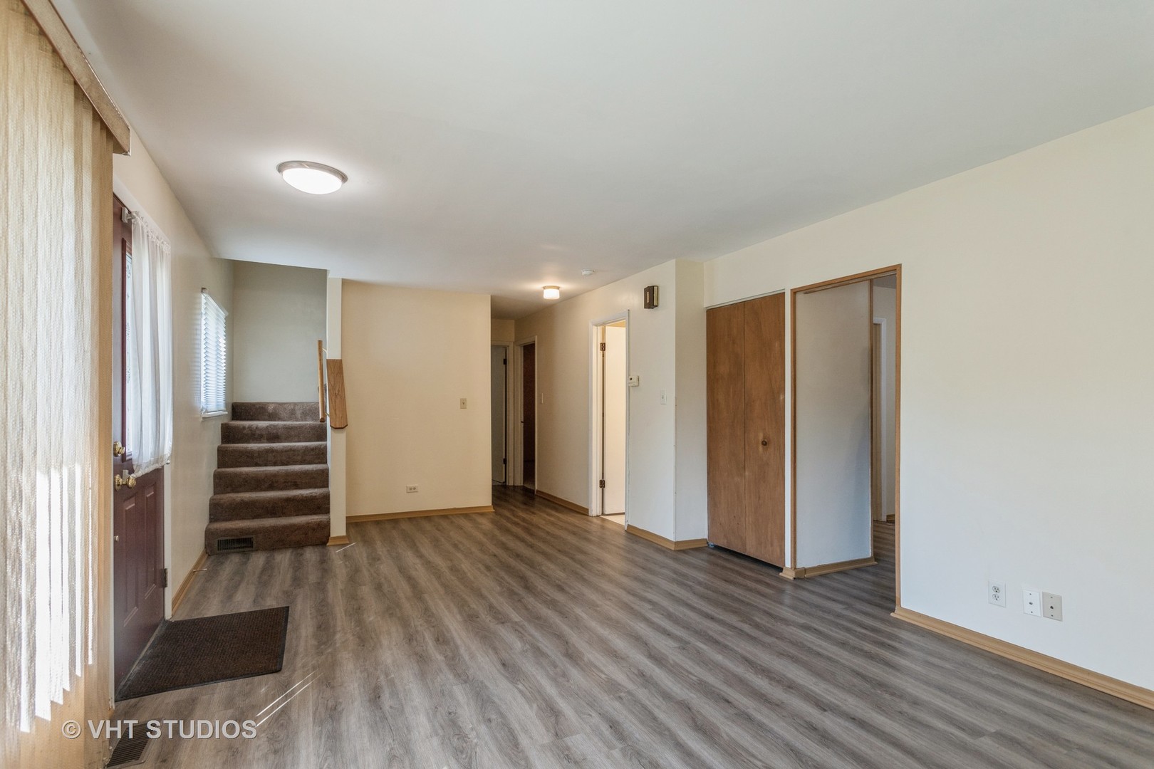 148 Springleaf Drive Bolingbrook, IL 60440 - Photo 5 of 24 a view of a hallway with stairs and wooden floor