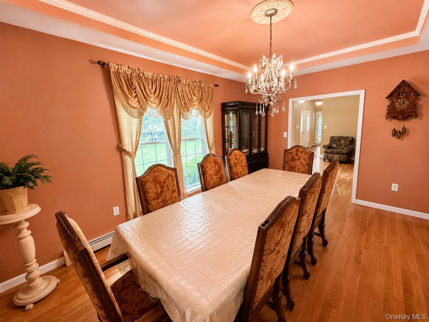 411 Mt Joy Road Middletown, NY 10941 - Photo 34 of 49 Dining area featuring wood-finish flooring, a tray ceiling with crown molding