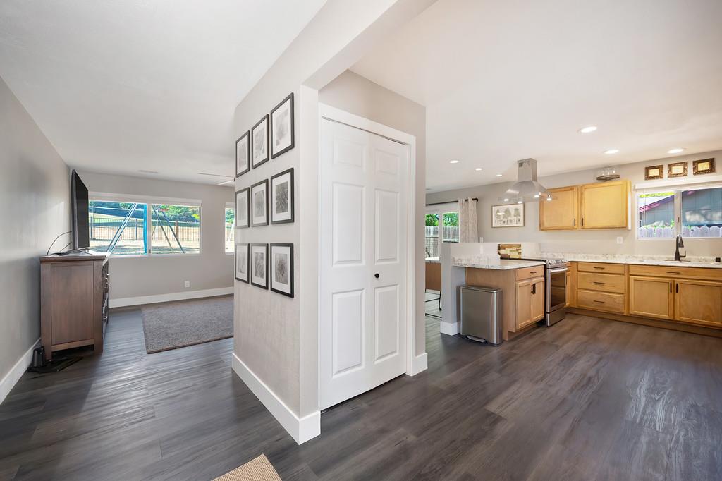 1679 American River Trail Cool, CA 95614 - Photo 1 of 1 a kitchen with a refrigerator a sink dishwasher with a dining table and chairs