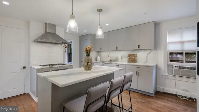 a kitchen with a sink a stove and cabinets