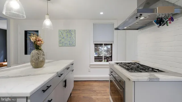 a kitchen with cabinets appliances a sink and a counter space