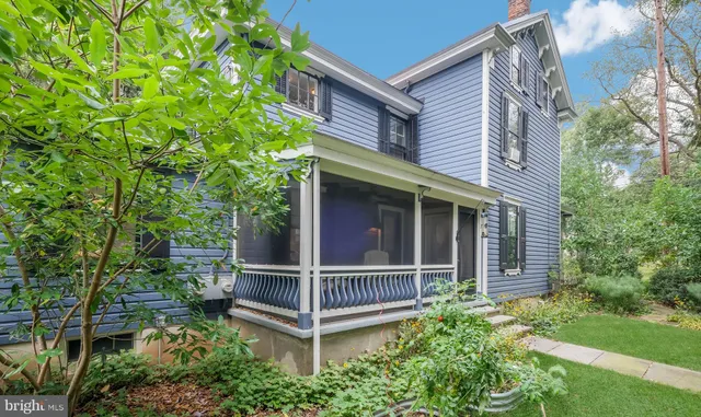 a dining room with furniture a chandelier and wooden floor