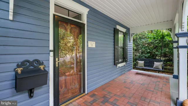 a view of a room with wooden floor and furniture