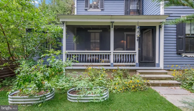 a view of a house with pool and garden