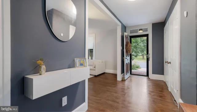 a view of a bedroom with wooden floor cabinet and windows