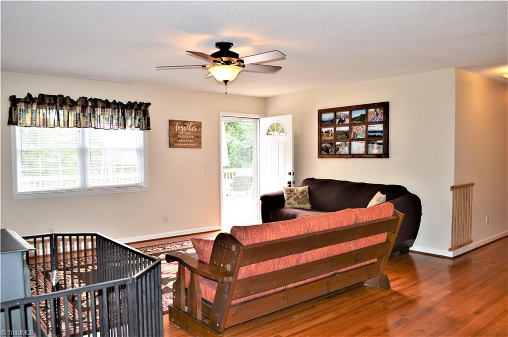114 Rink Road Mayodan, NC 27027 - Photo 3 of 30 Living Room: Wood Flooring, Ceiling Fan, Exterior Door leads to Large Deck, Wood Burning Wood-stove
