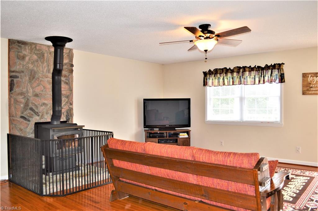 114 Rink Road Mayodan, NC 27027 - Photo 4 of 30 Living Room: Wood Flooring, Ceiling Fan, Exterior Door leads to Large Deck, Wood Burning Wood-stove
