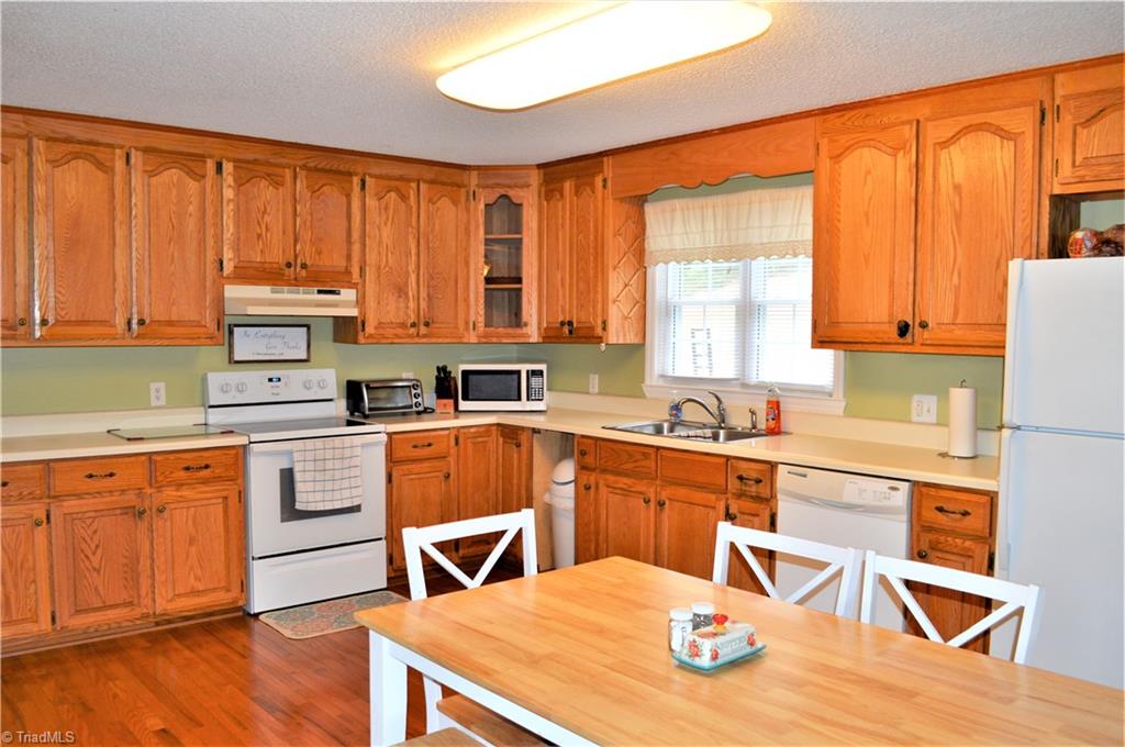 114 Rink Road Mayodan, NC 27027 - Photo 8 of 30 Kitchen: Beautiful Oak Cabinets, Wood Flooring, Lots of Cabinet and Counter Space, Dishwasher & Stove to convey