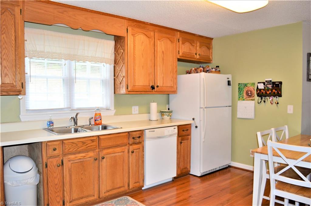 114 Rink Road Mayodan, NC 27027 - Photo 9 of 30 Kitchen: Beautiful Oak Cabinets, Wood Flooring, Lots of Cabinet and Counter Space, Dishwasher & Stove to convey