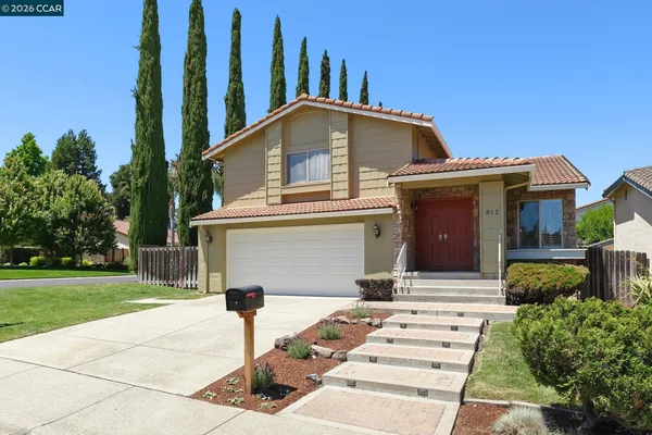a front view of a house with garden