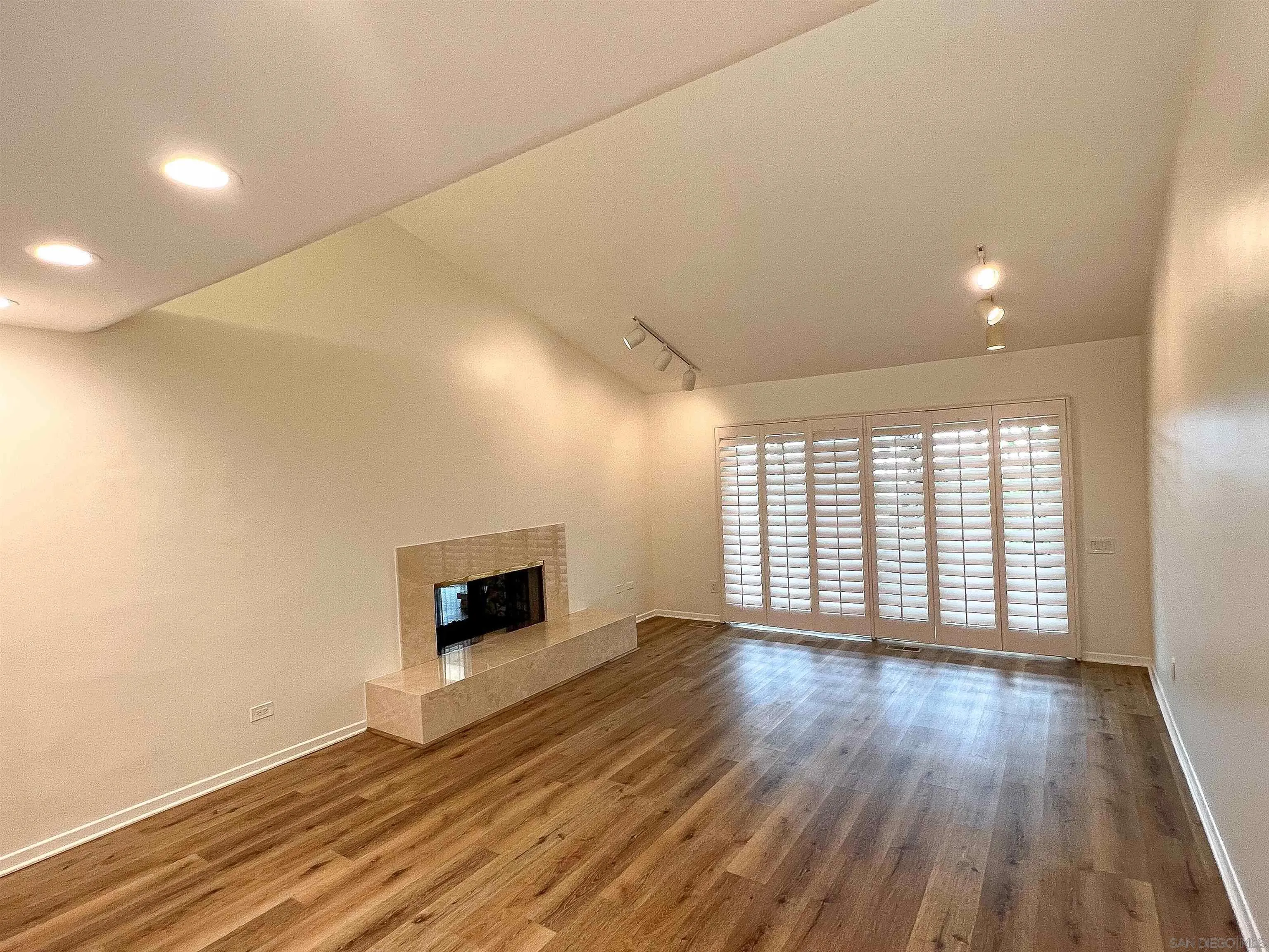1671 Paseo Bonita La Jolla, CA 92037 - Photo 12 of 17 an empty room with wooden floor and fireplace