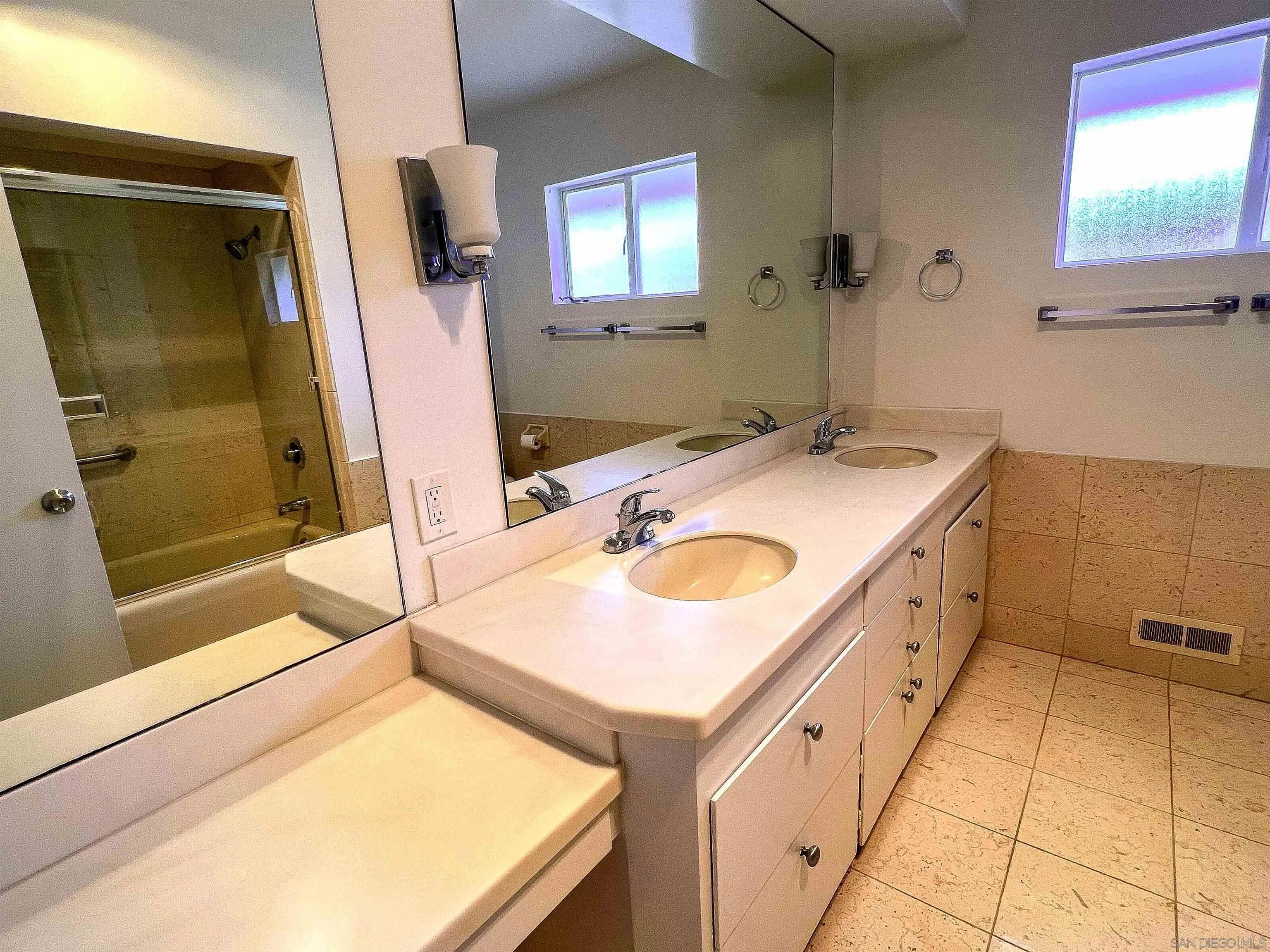 1671 Paseo Bonita La Jolla, CA 92037 - Photo 14 of 17 a bathroom with a sink and mirror with bathtub