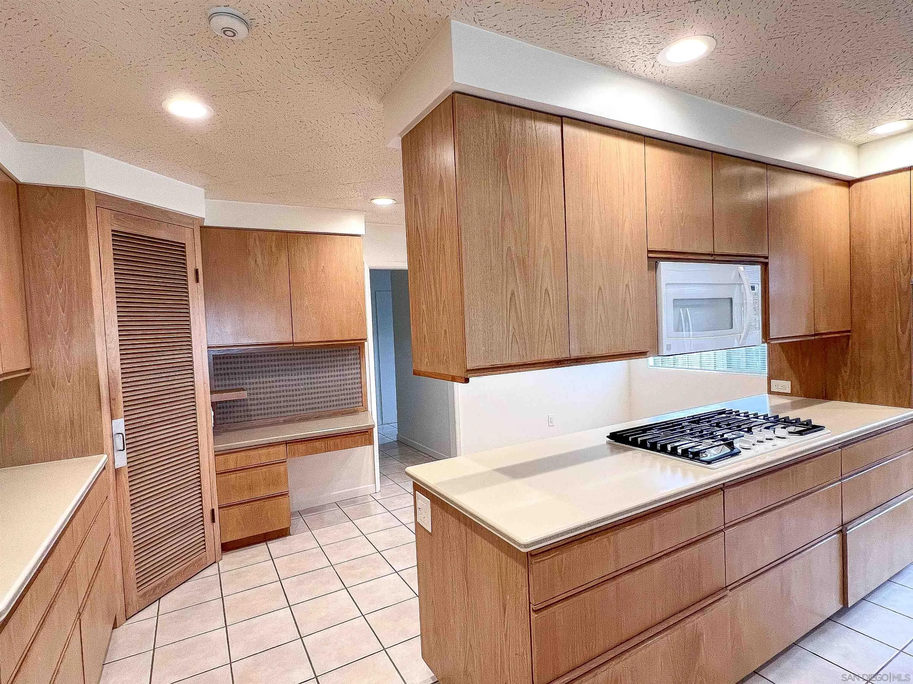 1671 Paseo Bonita La Jolla, CA 92037 - Photo 6 of 17 a kitchen that has a lot of cabinets in it