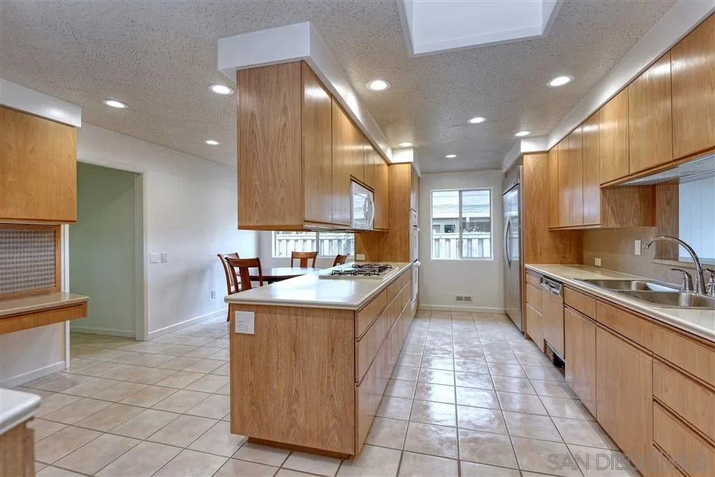 1671 Paseo Bonita La Jolla, CA 92037 - Photo 7 of 17 a kitchen with stainless steel appliances granite countertop a sink and a stove