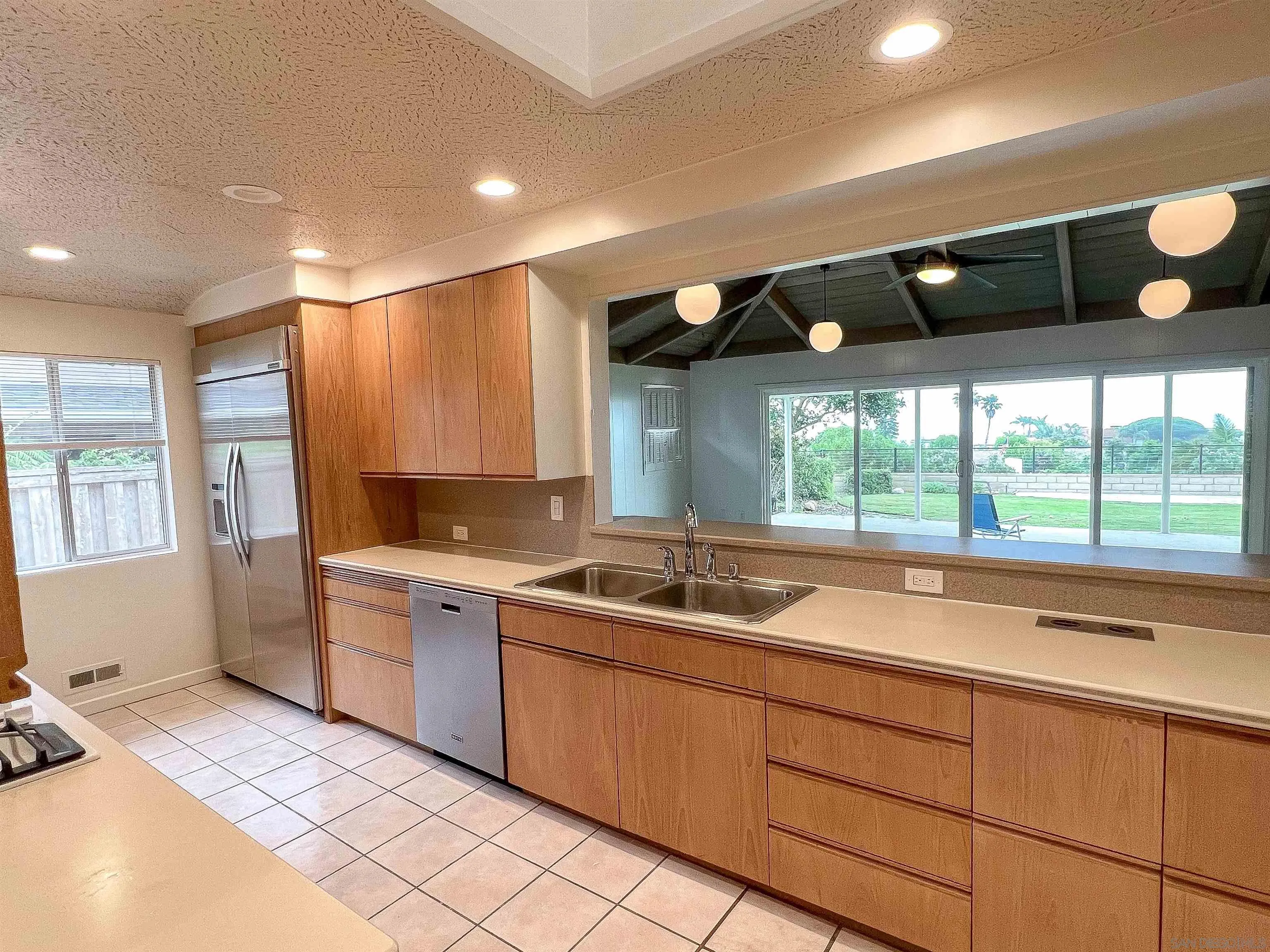 1671 Paseo Bonita La Jolla, CA 92037 - Photo 8 of 17 a kitchen with a sink and wooden cabinets