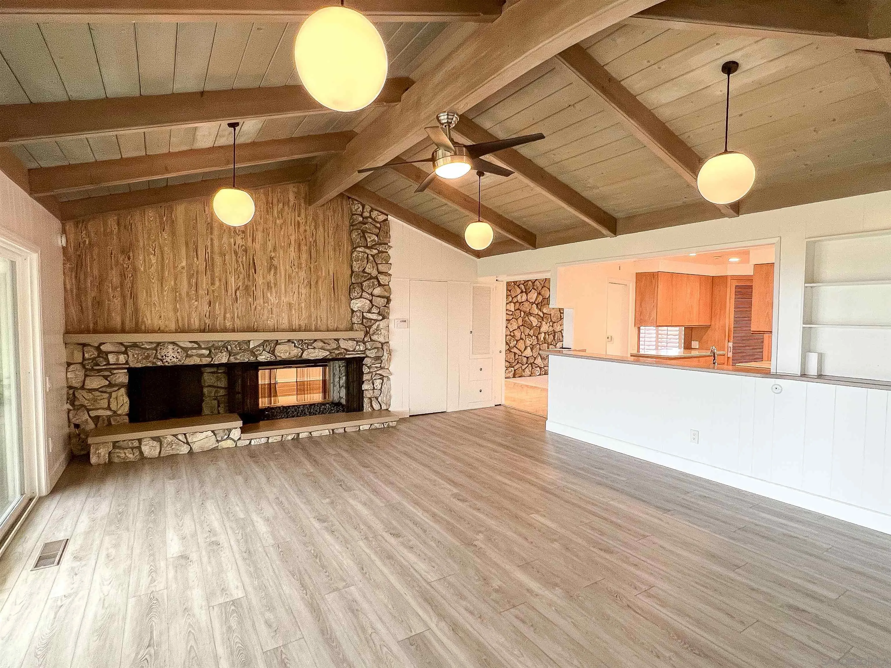 1671 Paseo Bonita La Jolla, CA 92037 - Photo 9 of 17 a view of a room with wooden floor and a ceiling fan