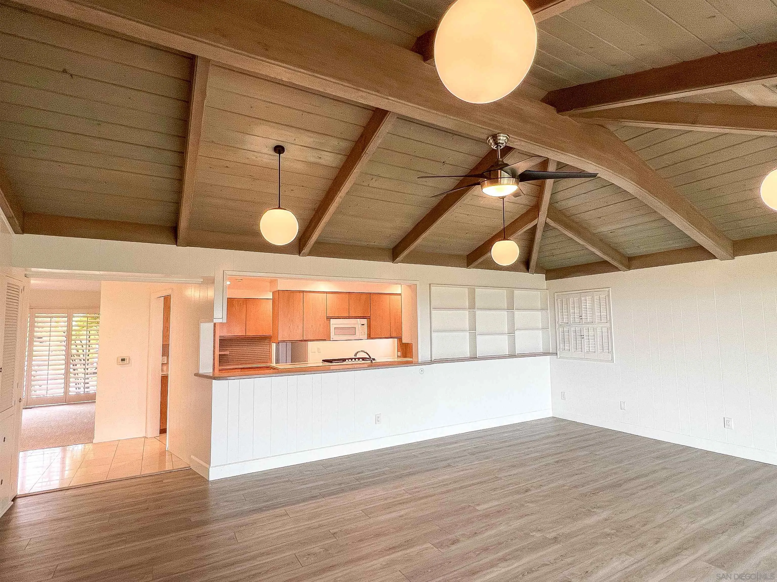 1671 Paseo Bonita La Jolla, CA 92037 - Photo 10 of 17 a view of a room with wooden floor and windows
