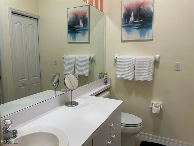 a bathroom with a sink toilet and vanity