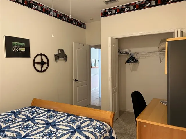 a bedroom with a bed and a chair with the outer view