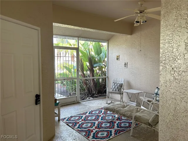 a living room with furniture and a rug