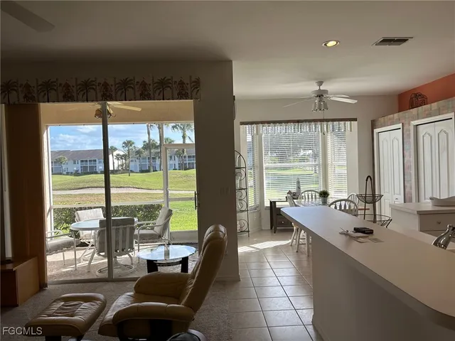 a room with furniture and large windows