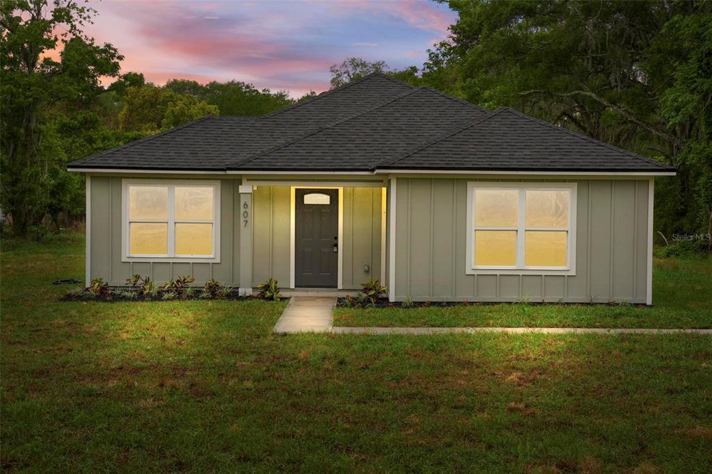 607 Thomas Avenue Leesburg, FL 34748 - Photo 1 of 50 a view of a house with backyard and garden