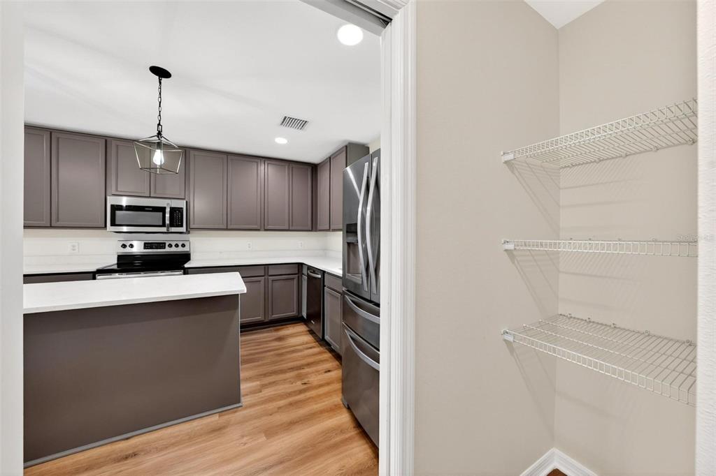607 Thomas Avenue Leesburg, FL 34748 - Photo 12 of 50 a kitchen with kitchen island a counter top space stainless steel appliances and cabinets