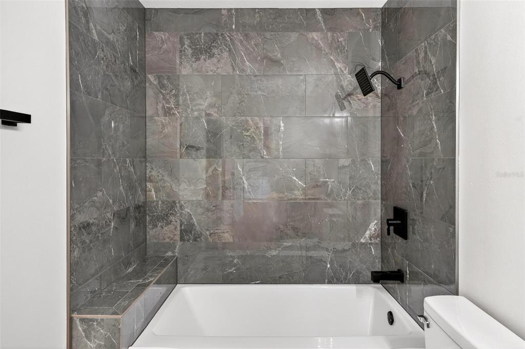 607 Thomas Avenue Leesburg, FL 34748 - Photo 16 of 50 a bathroom with a bathtub and a shower