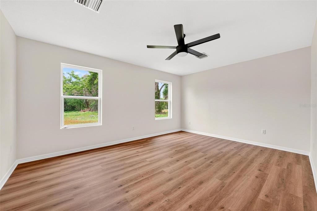 607 Thomas Avenue Leesburg, FL 34748 - Photo 17 of 50 a view of empty room with wooden floor and window