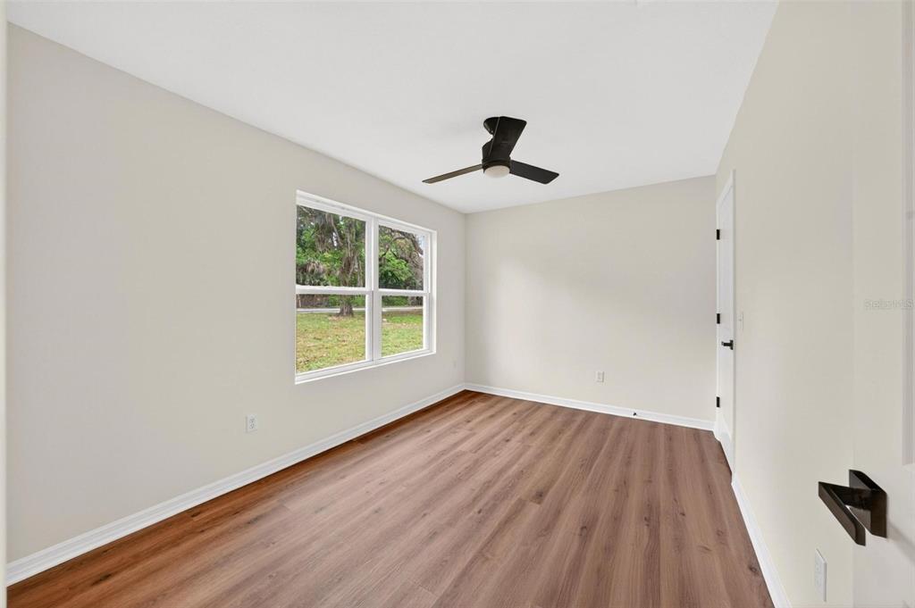 607 Thomas Avenue Leesburg, FL 34748 - Photo 18 of 50 wooden floor in an empty room with a window